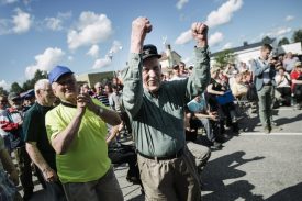 Huugo Jaakkonen from Salla, Finland, celebrates his 60 euro winning bid on the first car auctioned as Asylum seekers' abandoned cars are sold off in Salla, northern Finland, on Friday July 15, 2016. Over 100 old cars, mostly Russian-made, driven across the northeastern Finnish border by asylum seekers and abandoned at the Salla border crossing point this past winter are auctioned in a two-day event in Salla. (Jouni Porsanger/Lehtikuva via AP) FINLAND OUT - NO SALES
