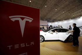 People visit a Tesla Model S car during the Auto China 2016 in Beijing, China, April 25, 2016. REUTERS/Jason Lee/File Photo