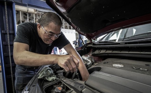 man repairing a car